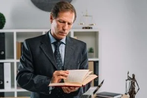 mature lawyer turning pages law book